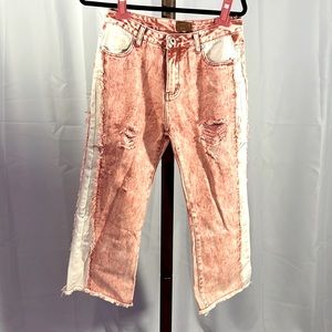 Acid washed distressed denim jeans.